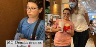 menino no McDonald's segurando batata frita e refrigerante ao lado de atendente